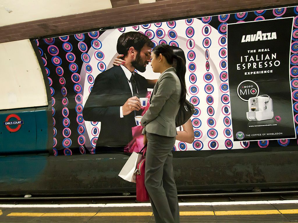 A commuter finds herself in a romantic moment with the advertising on the London Underground (advertising picture used with permission from Lavazza)