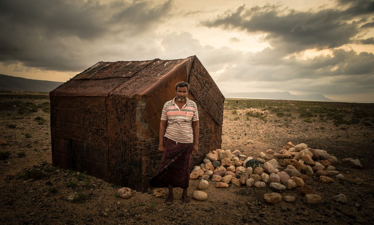 Approaching rain over oil drum house. These houses where made from discarded oil drums on the island of Socotra, off the coast of Yemen