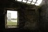 The view of Carrigafoyle Castle in Ballylongford, North Kerry, Ireland from an abandoned house across the river stream.